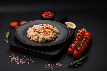 Delicious boiled rice with vegetables peppers, carrots, peas and asparagus beans