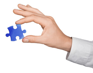 Businessman Hand Holding a Puzzle Piece