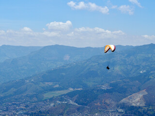 Medellin, Colombia - 20.05.2015: Parafoil of a paraglider flying above Medellin