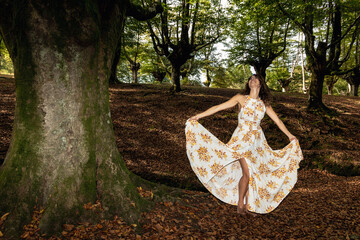 Tranquil Nature Bliss: A Serene Woman in a Long Dress Amongst Lush Woods