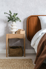 Fototapeta na wymiar stylish hotel room with bed, wood bedside table and floor rug