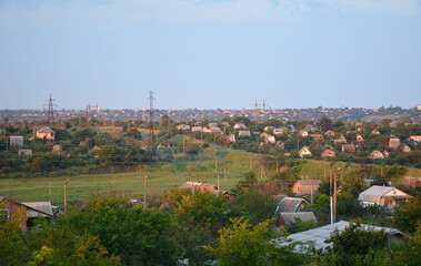 top view of a small village with private houses. the houses are painted orange because of the rays of the setting sun. beauty in nature