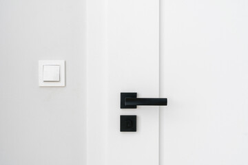 door knob with latch at hotel room with stylish interior