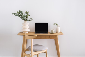 workplace with netbook and wooden table in minimalism style