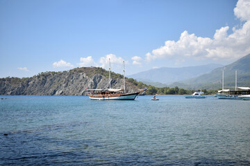 Pleasure ship in the bay at sea. Ship. mountains, forest, beaches. Türkiye, Phaselis