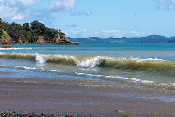 High tide waves at Orere Point Beach Reserve, Auckland, New Zealand