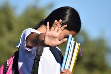 Shameful Cute Minority Person Wearing School Uniform Holding Books