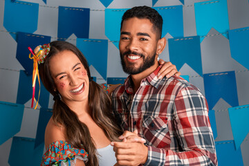 Festa Junina: party in Brazil, fun couple dancing at June Festival in traditional clothes.