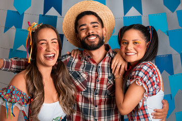 Brazilian Festa Junina, portrait of friends smiling at Party in June in traditional clothes.