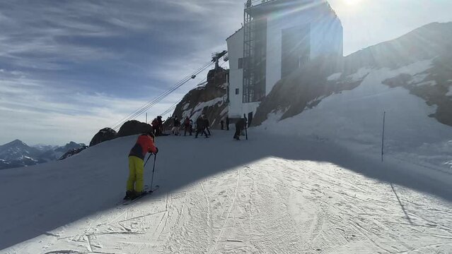 Skiing season footage in the Dolomites mountains in Italy on a beautiful sunny day