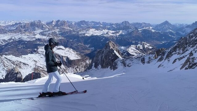 Skiing season footage in the Dolomites mountains in Italy on a beautiful sunny day