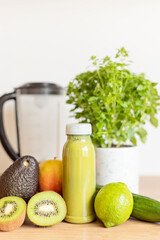 Healthy fresh avocado, kiwi, banana and cucumber green smoothie with assorted ingredients....