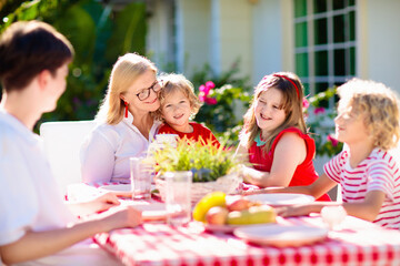 Family eating outdoor. Garden summer fun.