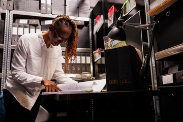 Woman detective reading crime case file, analyzing witness testimony and searching insight. African...