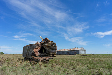 Freight train car wrecked by a crash. Dropped off at old abandoned train station. Argentina.