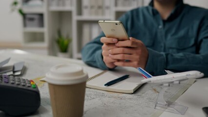 Agency, Experienced consultant Slowly Holds a mobile phone In the office of the company The camera is in motion Employee at the workplace Serves clients Provides services for tourists, visa
