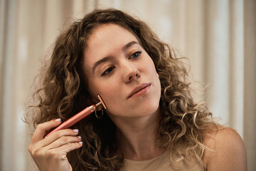 Facial skincare using gadgets and serums for smoother, moisturized skin and reduced wrinkles.