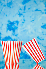 Obraz premium front view popcorn packages on a light blue background food snack friends cips corn color company