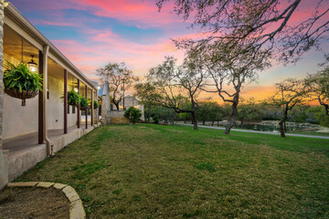 a farmhouse at sunset