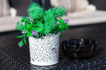 Pots with flower on the tables of cafe