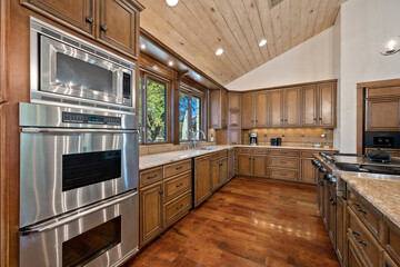 a farmhouse kitchen with wood floors and accents
