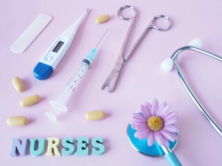 Concept of nurses A Pink background with medical equipment pills and a Pink flower