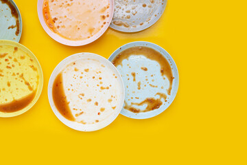 Dirty dishes on yellow background. Top view