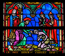 Prodigal son parable stained glass, Notre-Dame of the Assumption, Sainte-Marie-du-Mont, Normandy, France. Church created 11th to 13th Century.
