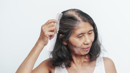 Naklejka premium Close up older elderly asian chinese woman gray hair worry cancer worry about hair loss