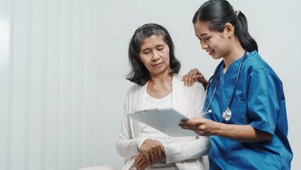 Senior older elderly patient asian grandmother woman with nurse consulting, safety and support of help, trust of breast cancer awareness, encourage
