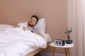 Sleepy man awaking in bed at home