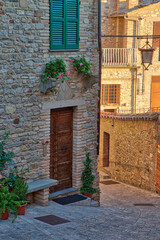 Fototapeta na wymiar Italy, Umbria. Entry of a home decorated with flowers in the historic town of Montone.