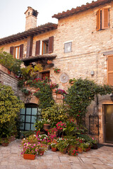 Fototapeta na wymiar Italy, Umbria. Colorful flowers outside a home in the Italian hill town of Assisi.