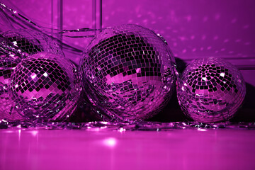 Shiny disco balls indoors, toned in purple