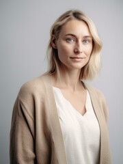Obraz premium Portrait of a young woman with blond hair on a gray background