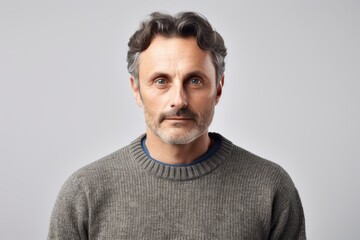 Fototapeta premium Portrait of a handsome middle-aged man wearing a grey sweater