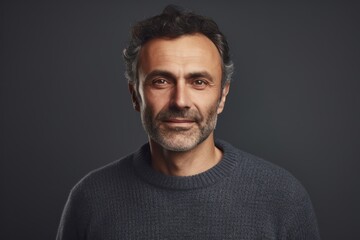 Obraz premium Portrait of handsome middle-aged man in grey sweater looking at camera