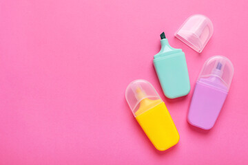 Many colorful markers on pink background, flat lay. Space for text