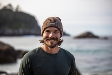 Lifestyle portrait photography of a grinning man in his 30s wearing a warm beanie or knit hat against an island resort or vacation background. Generative AI