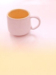 A white cup with yellow inside 