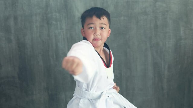 Asian boy practicing taekwondo, a martial art, karate martial arts