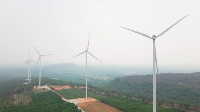 the aerial view of the the wind turbines plant or electric power generators on the mountain