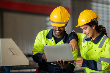 Factory apprenticeship. Man mentor teaching Female employees trainee operating machine looking...