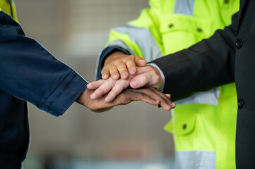 Group of young Engineer United stack hands or join hand teamwork together with Spirit diversity solidarity team Partner in metal sheet factory. Joins hands together teamwork meetings empower.