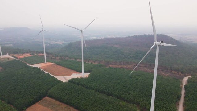 the aerial view of the the wind turbines plant or electric power generators on the mountain