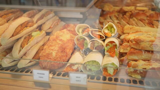 Display of bakery in Paris, France. Sandwiches and wraps and bread.