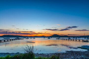 Sunrise waterscape with boats and clouds