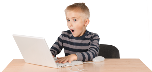Young boy surprised working on a laptop