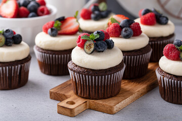Chocolate cupcakes with cream cheese frosting and fresh berries