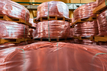 Stacks of copper wire rods in production plant warehouse